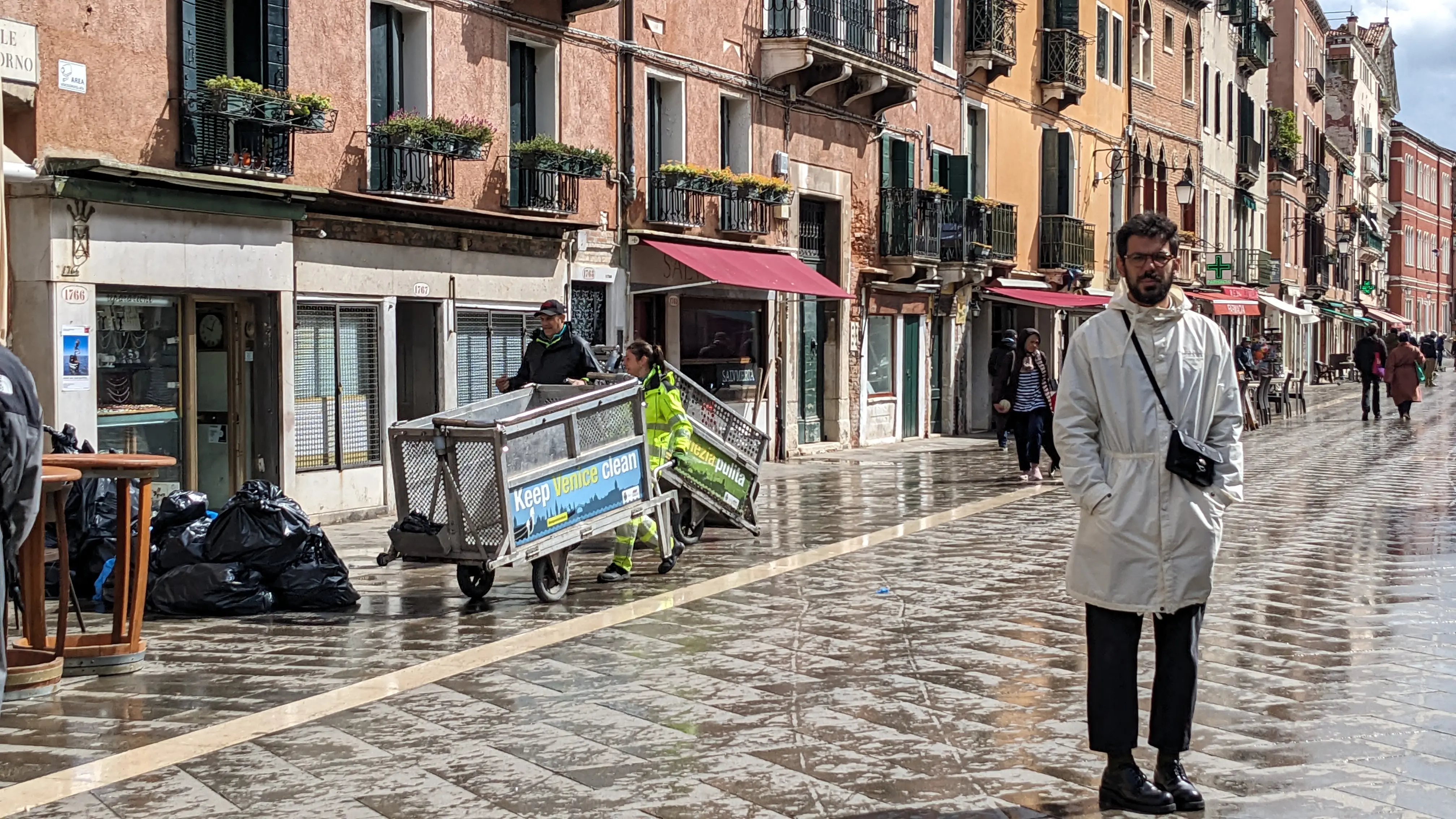 2 people loading garbage bags into carts