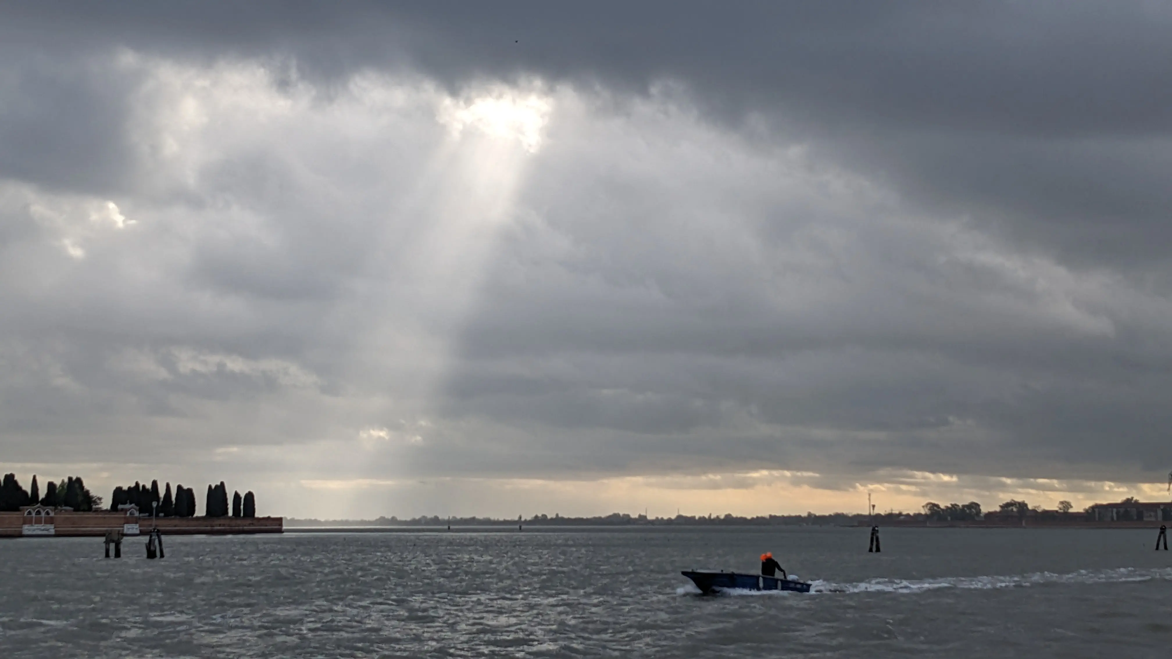 A person driving their boat outside of the main Venice island