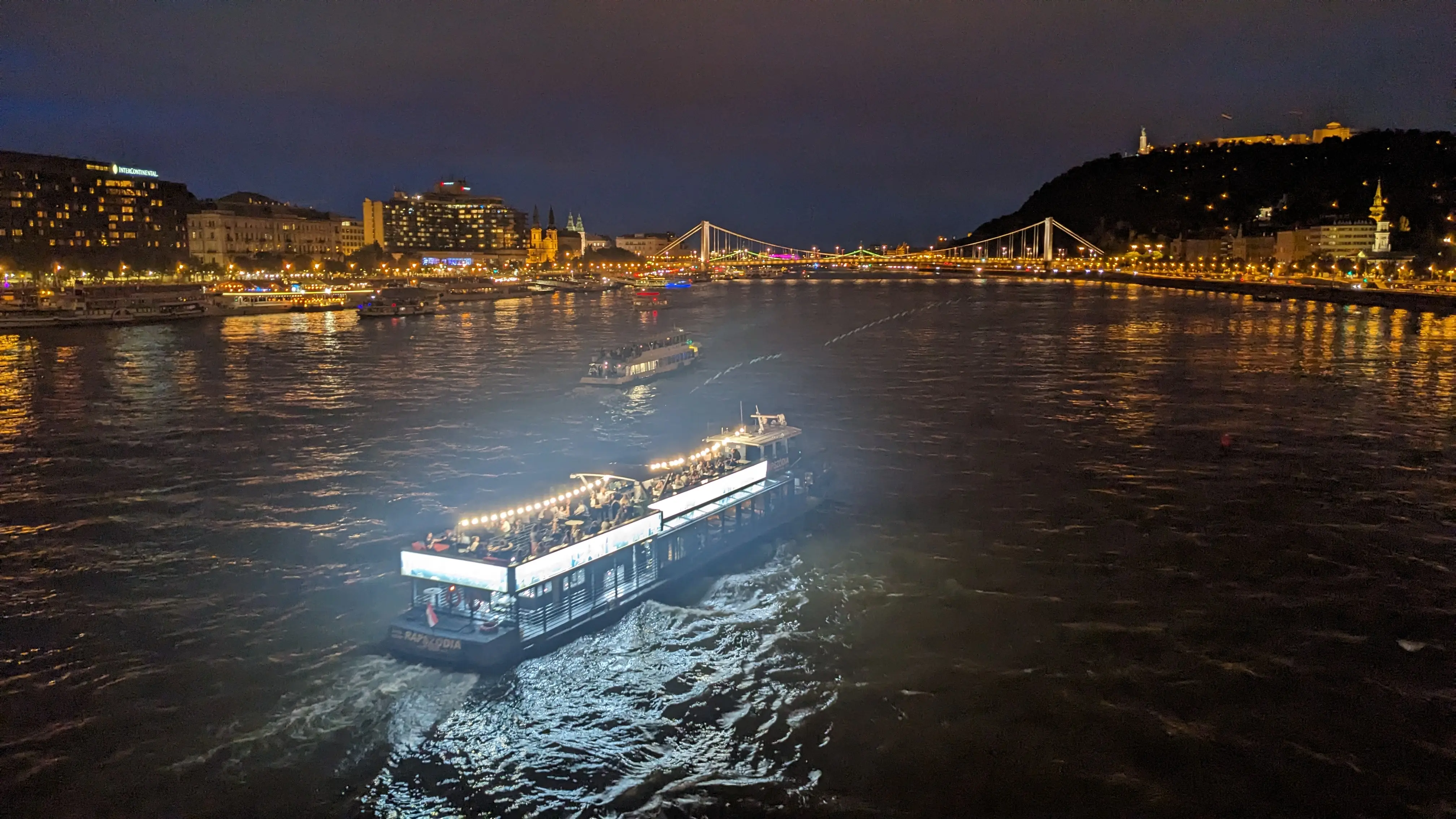 A view of the Danube river from a bridge after dark